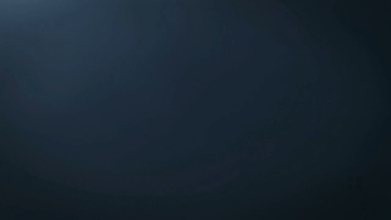 A dark studio background