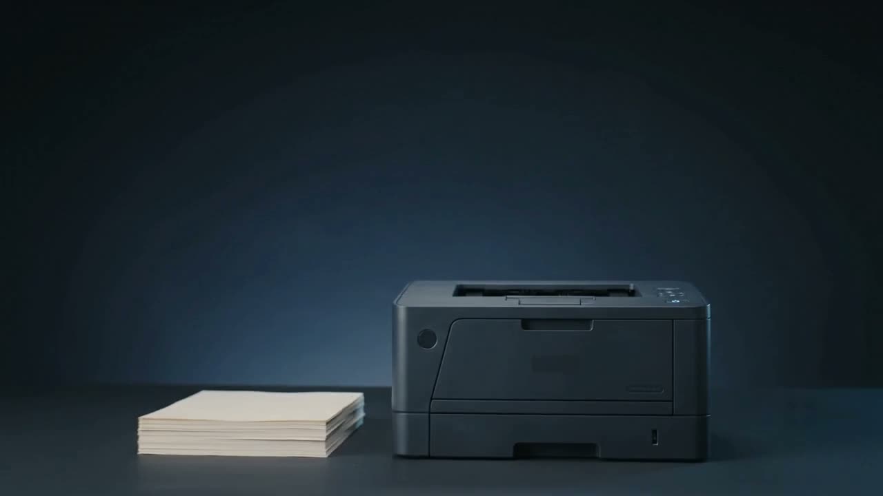 A serviced printer beside a stack of finished prints
